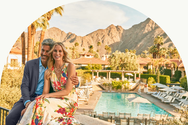 Couple dressed up with Tommy Bahama Miramonte Resort backdrop