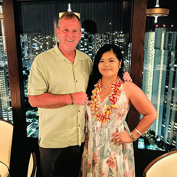 A couple wearing festive Tommy Bahama attire