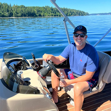 A Man sitting in a boat on the water