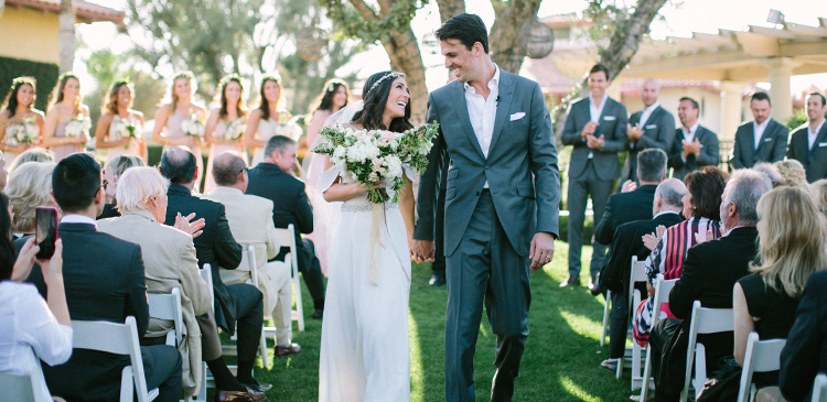 Bride and Groom walking down the Miramonte Lawn